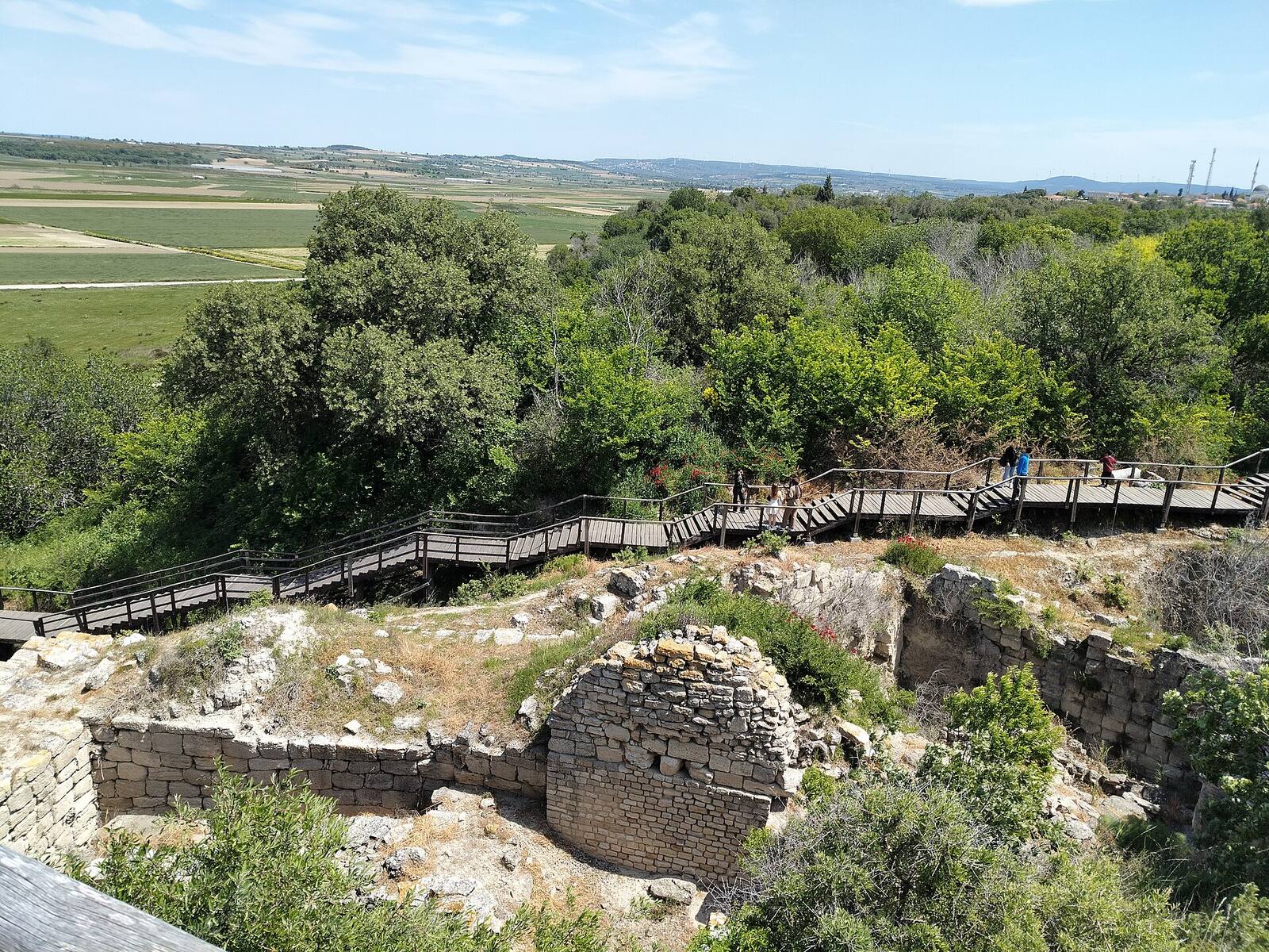 Hisarlık, a low hummock barely distinguishable from the plain around it. Beneath today's visitor path lies fifteen metres of accumulated city.